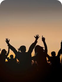 Crowd silhouette dancing at sunset
