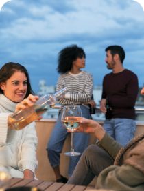 Friends socialising outdoors with drinks