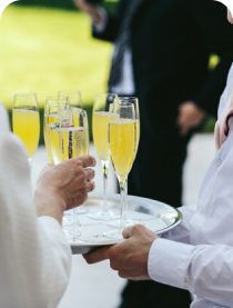 Guests holding champagne glasses at an event