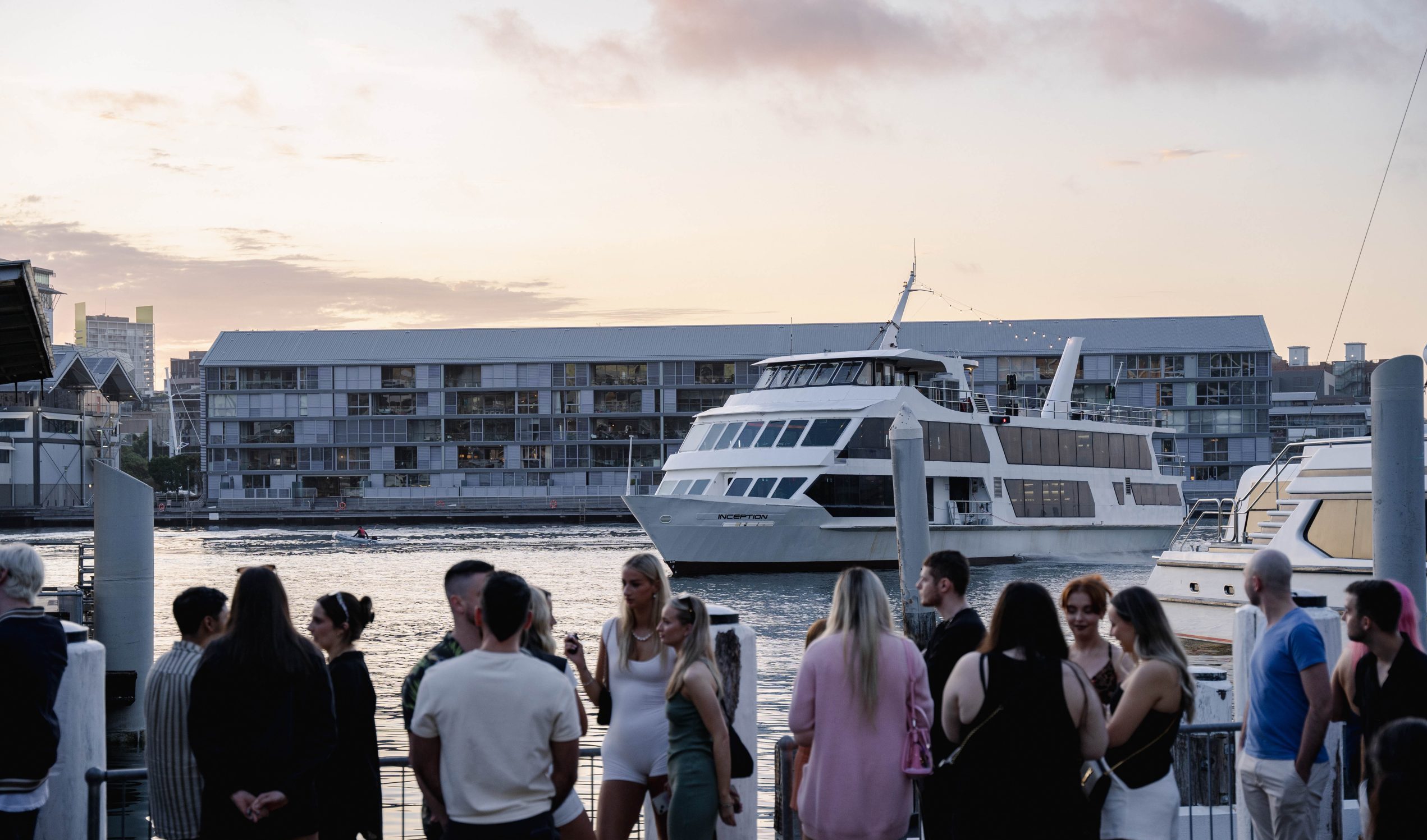 Guests boarding a luxury yacht at sunset