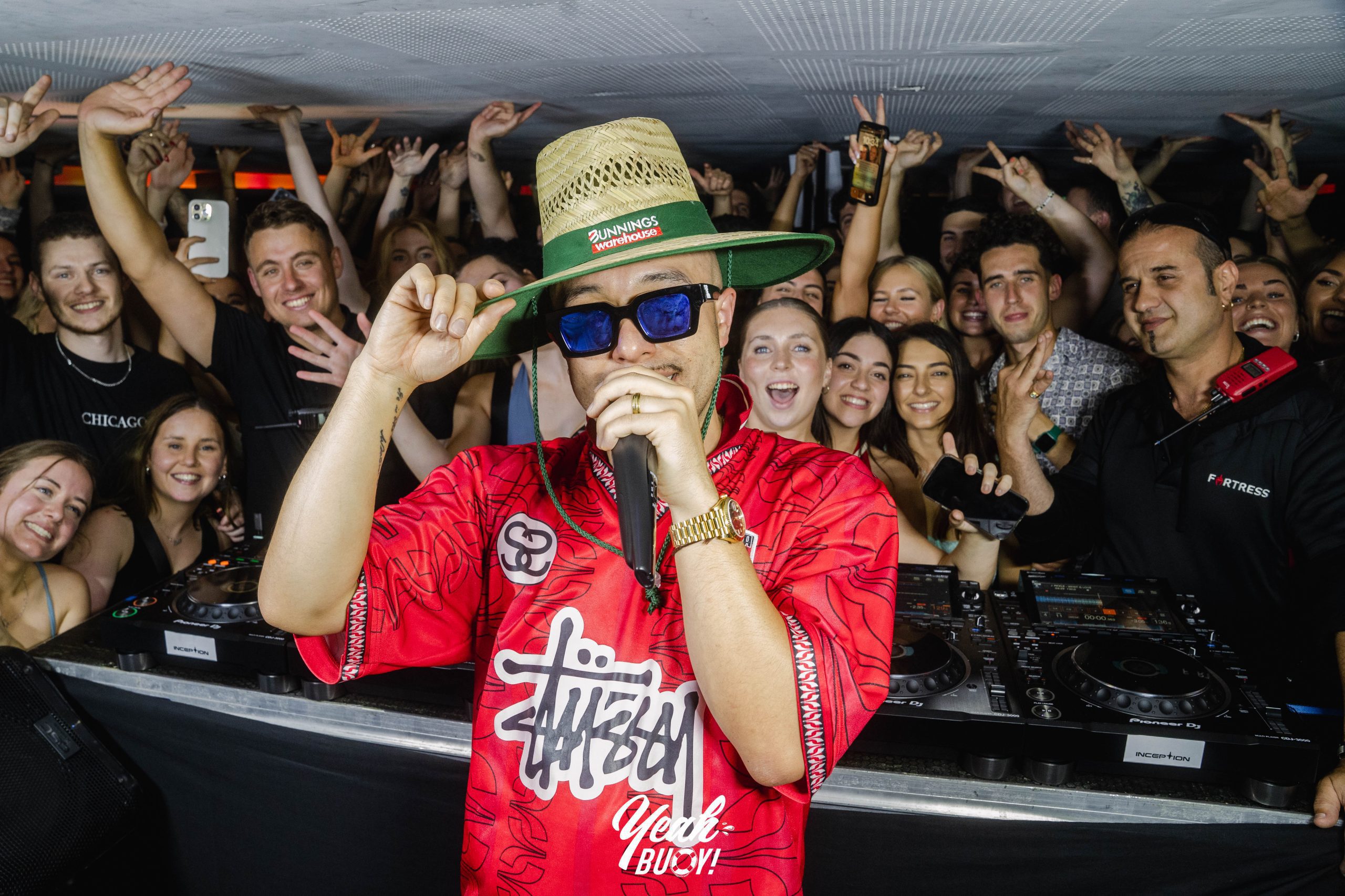 DJ wearing sunglasses performing at a yacht party