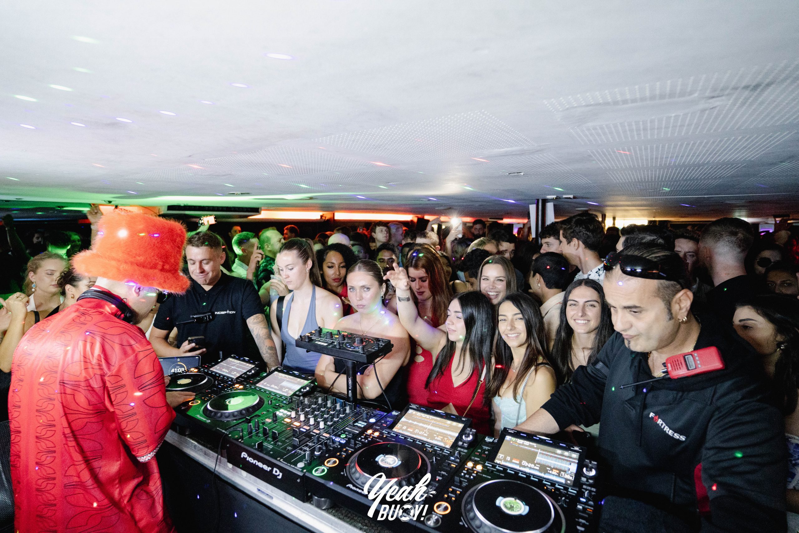 DJ performing to a packed yacht party crowd