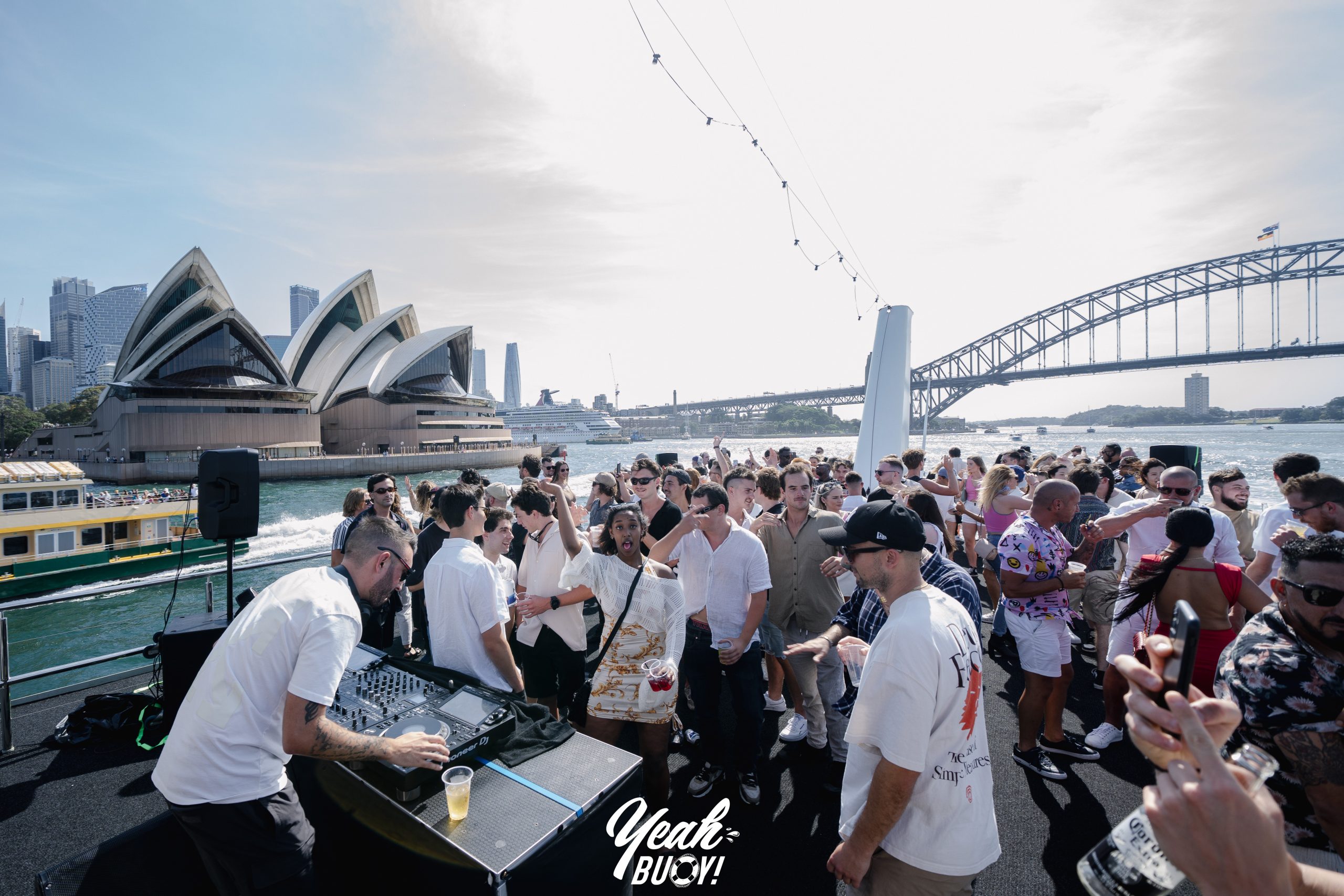 Guests socialising on a yacht beside Sydney Harbour