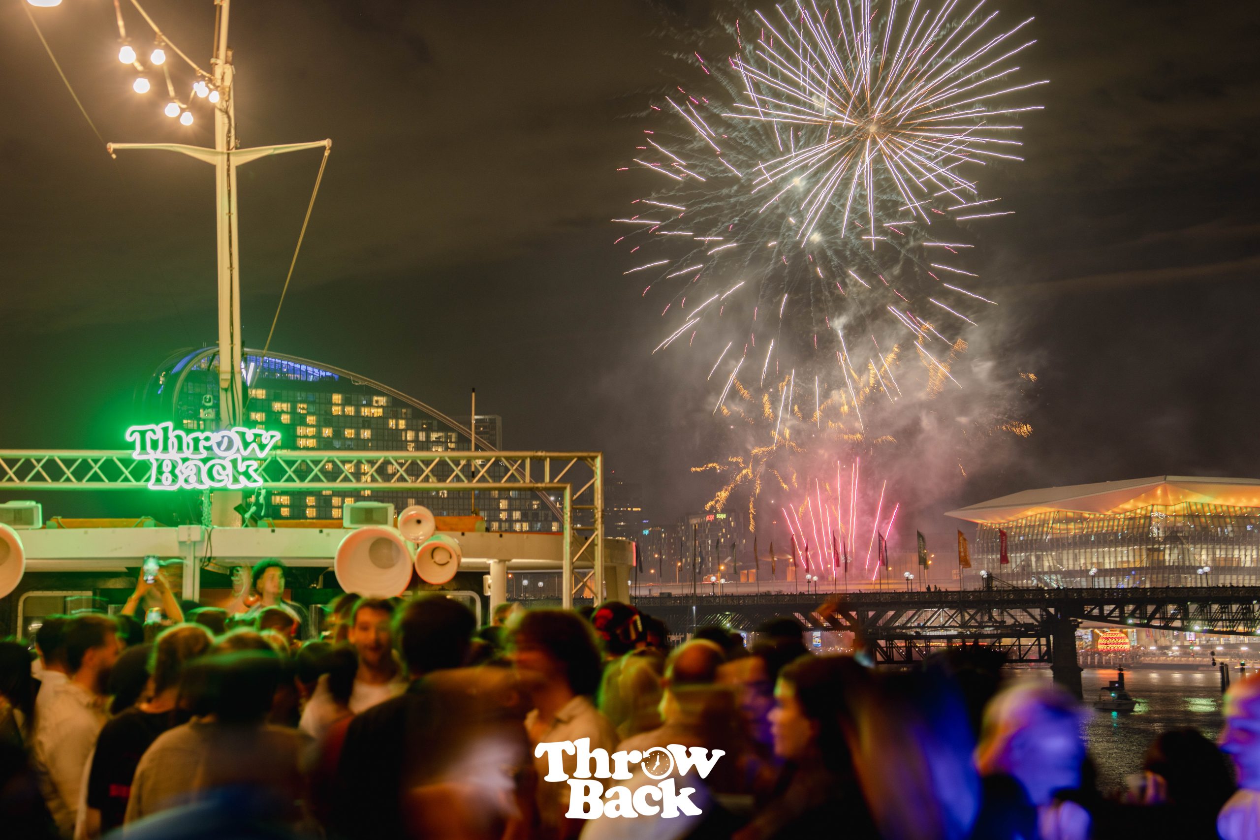 Fireworks display above a yacht party crowd