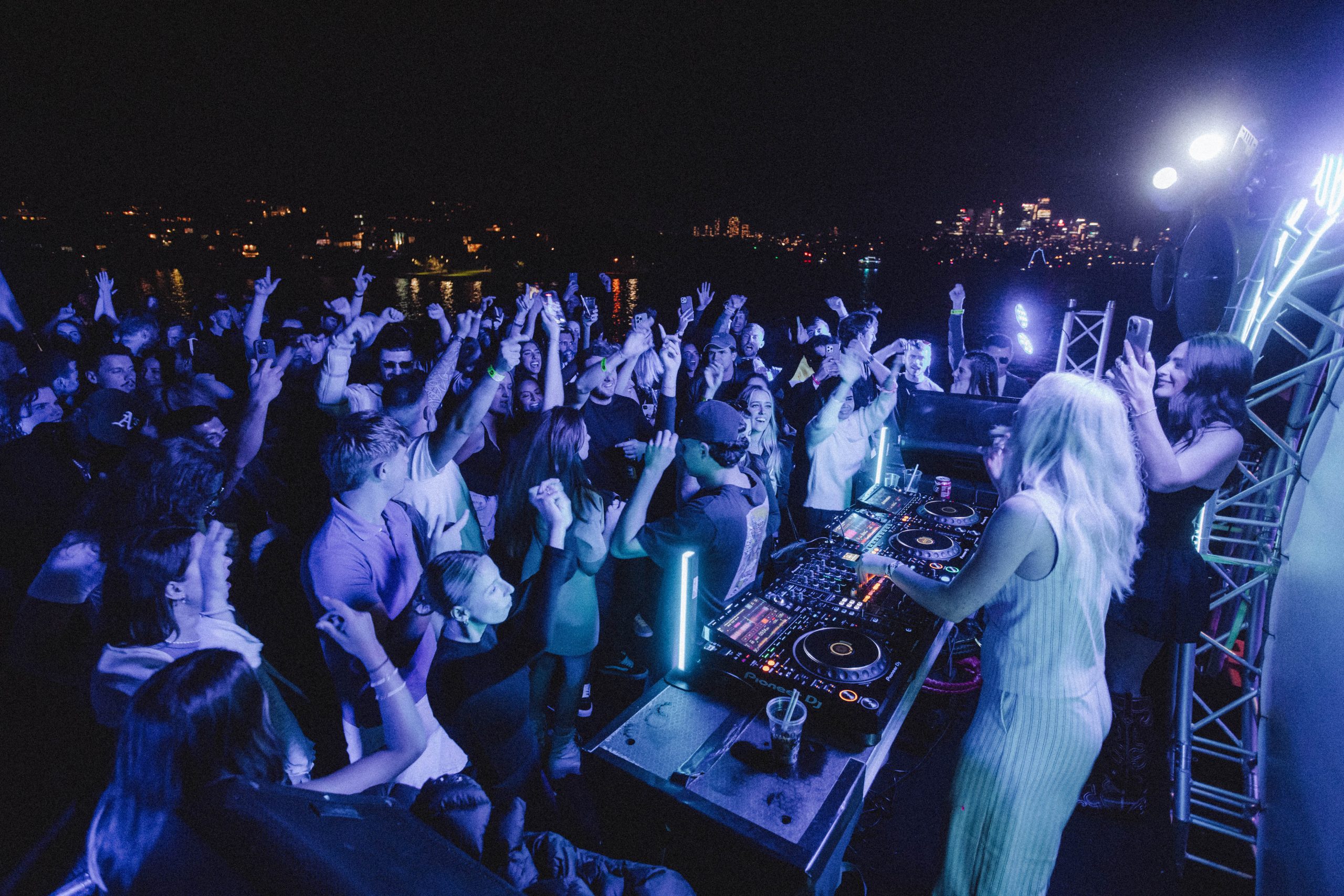 Crowd dancing at a vibrant harbour party