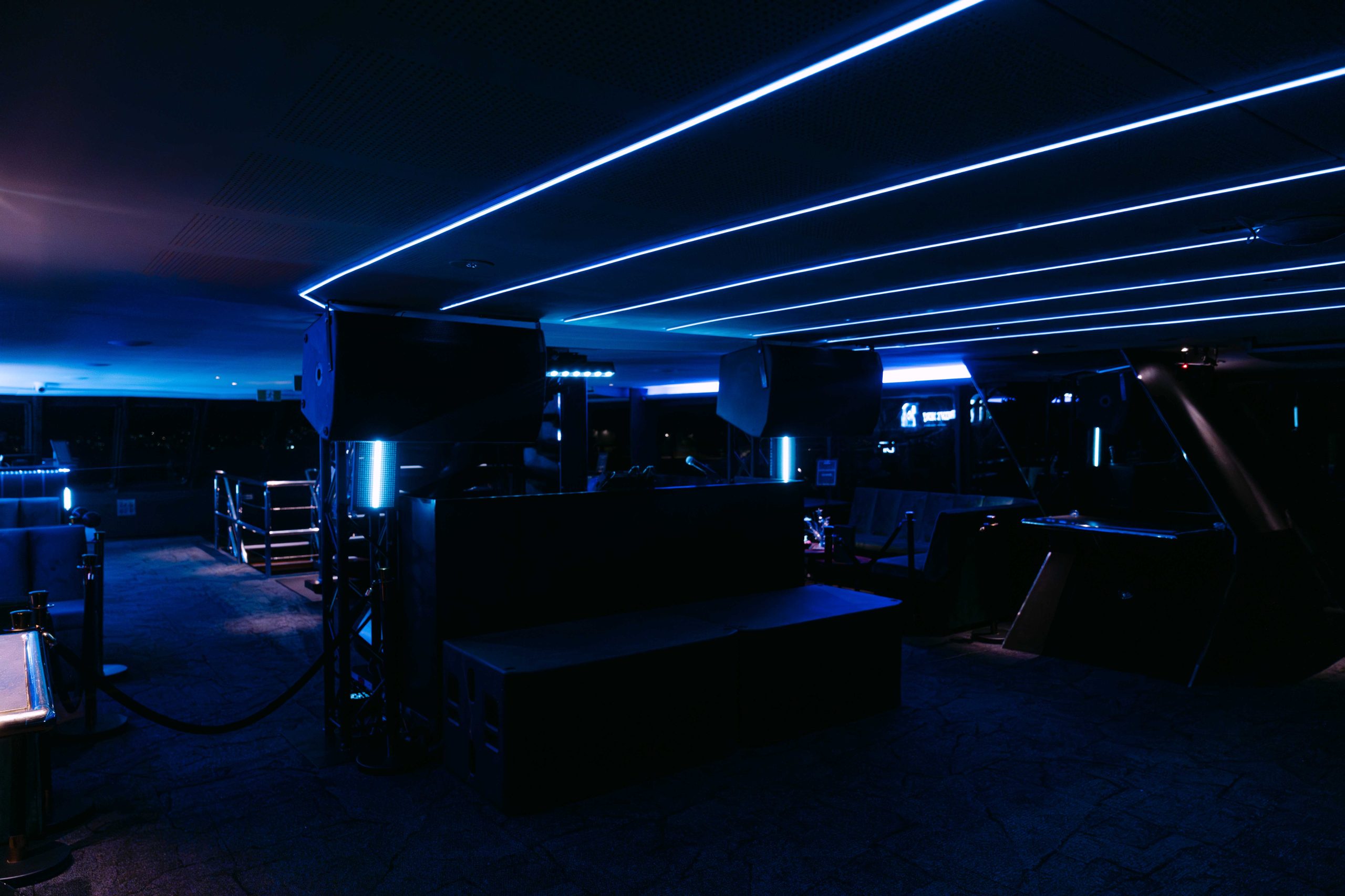 Modern yacht lounge illuminated with blue neon lights
