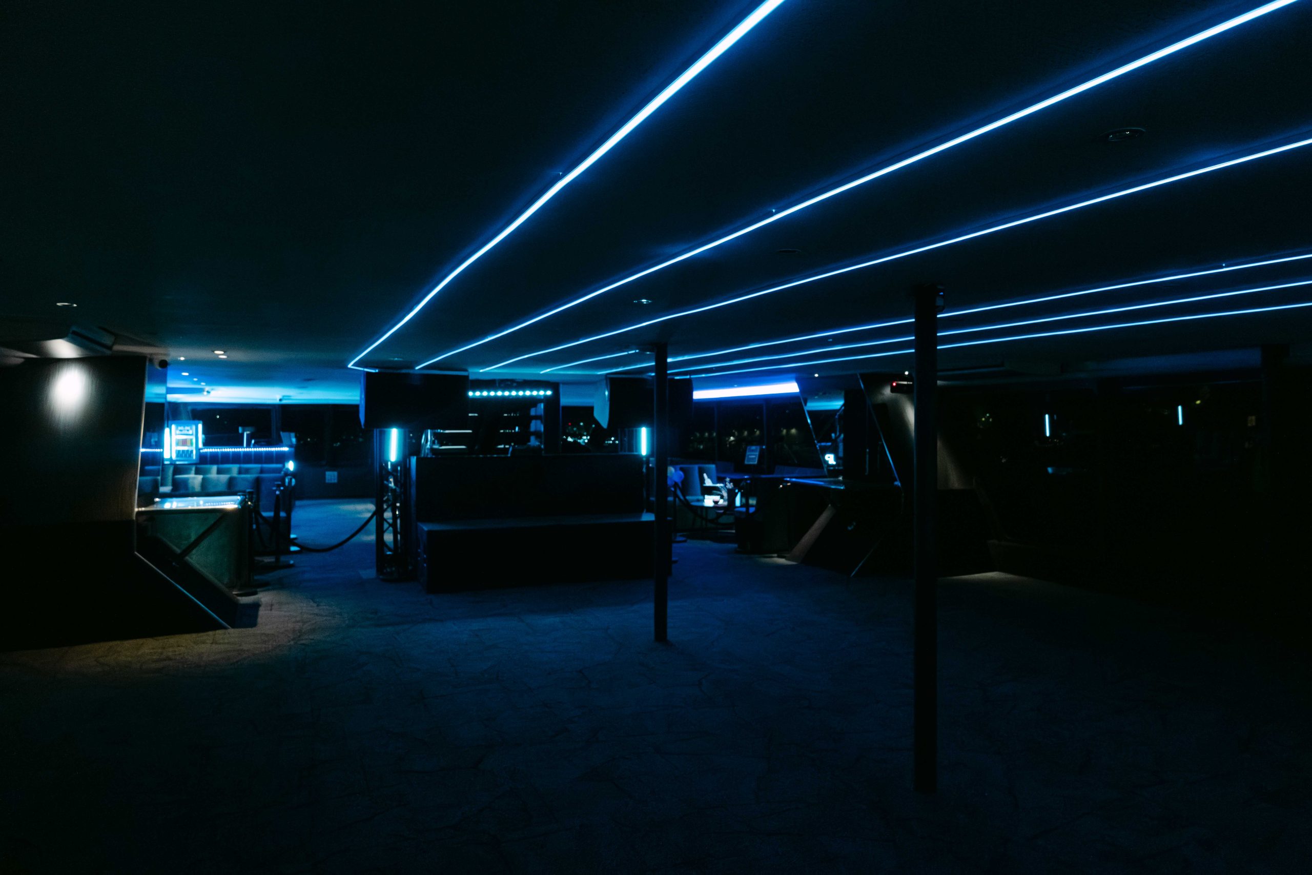 Blue neon-lit interior inside a luxury yacht venue