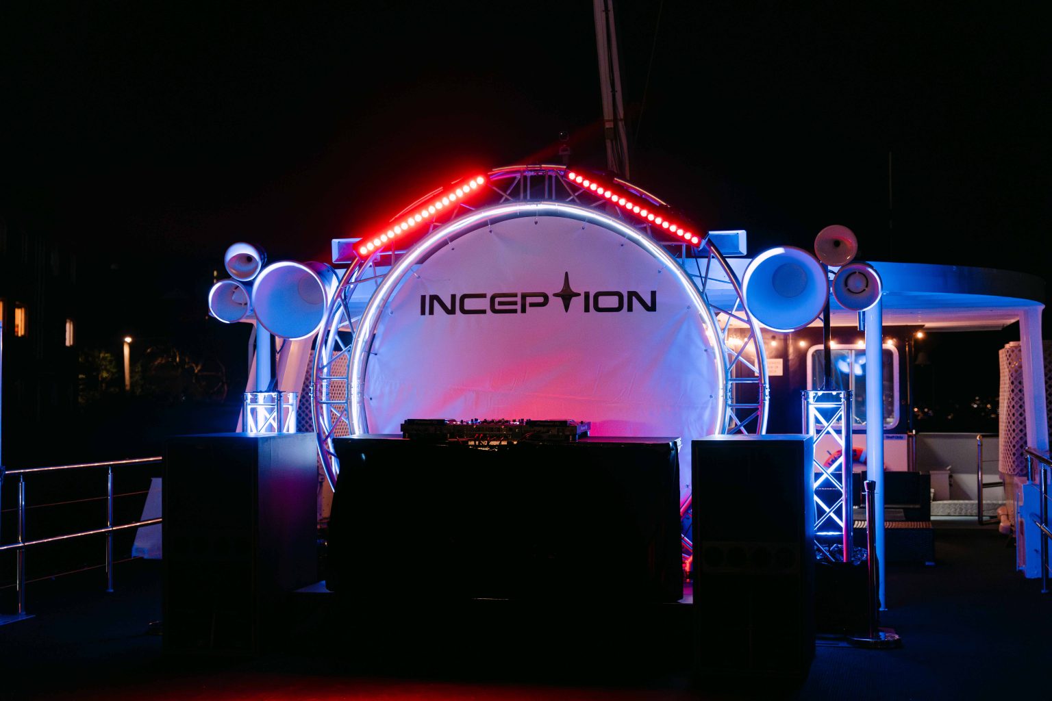 Night-time event entrance with glowing neon lighting