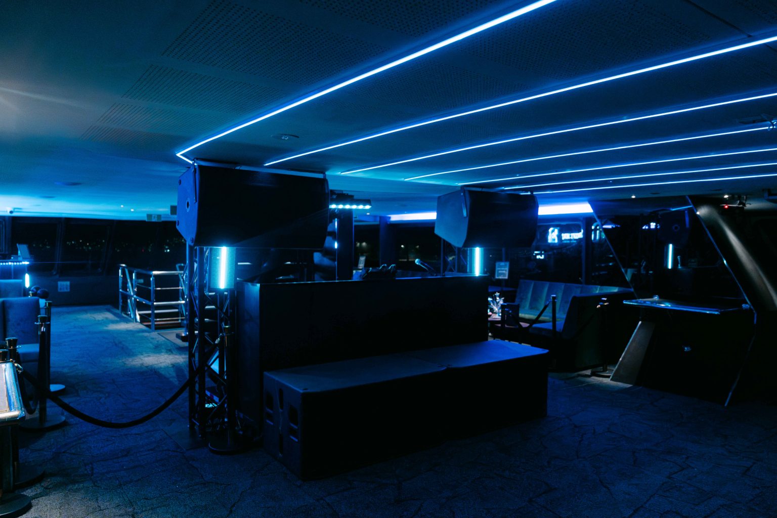 Blue-lit nightclub-style interior onboard a yacht