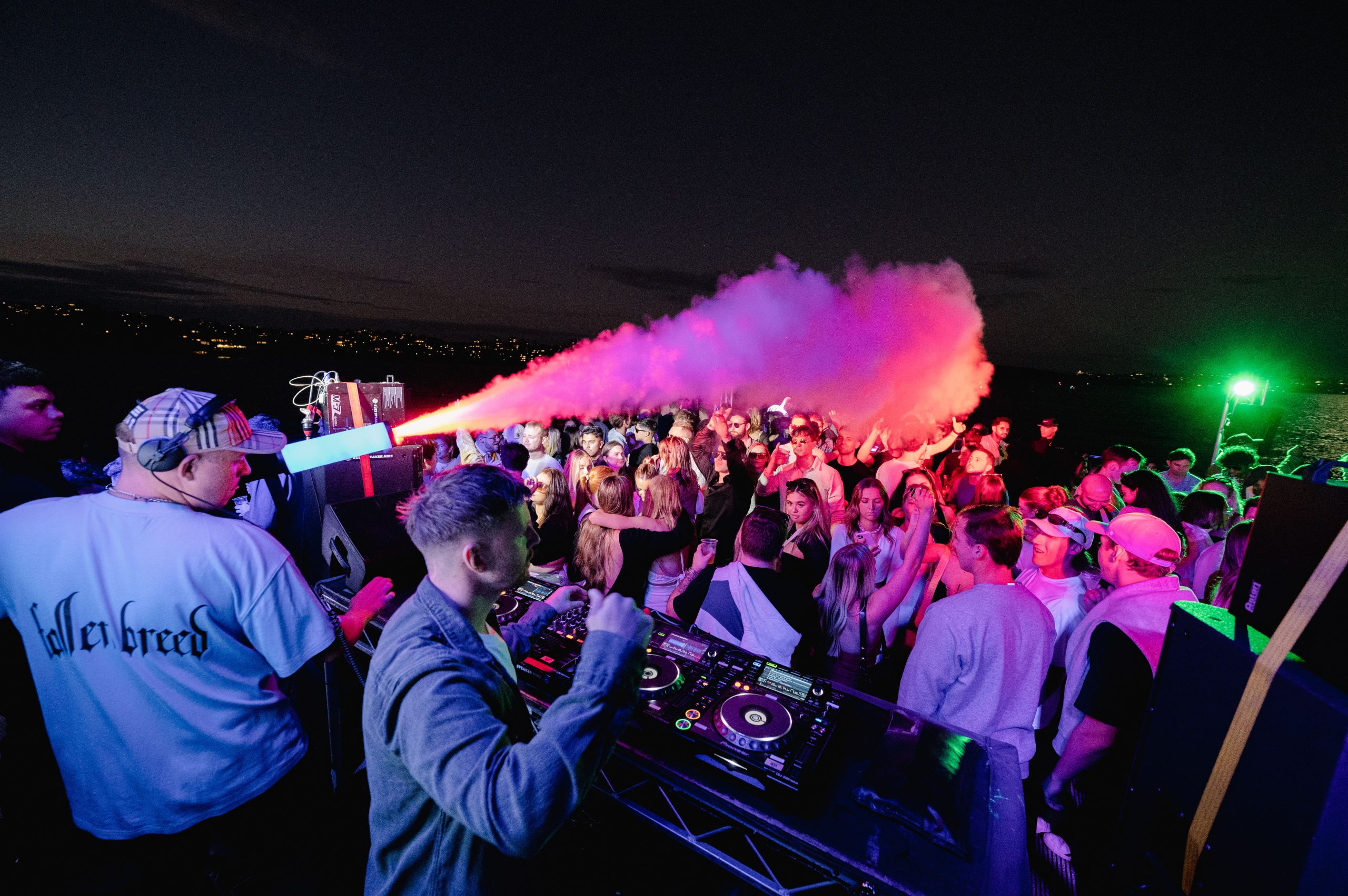 DJ performing at a lively yacht party