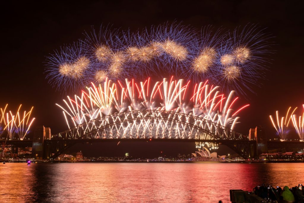 Red fireworks lighting up Sydney Harbour Bridge