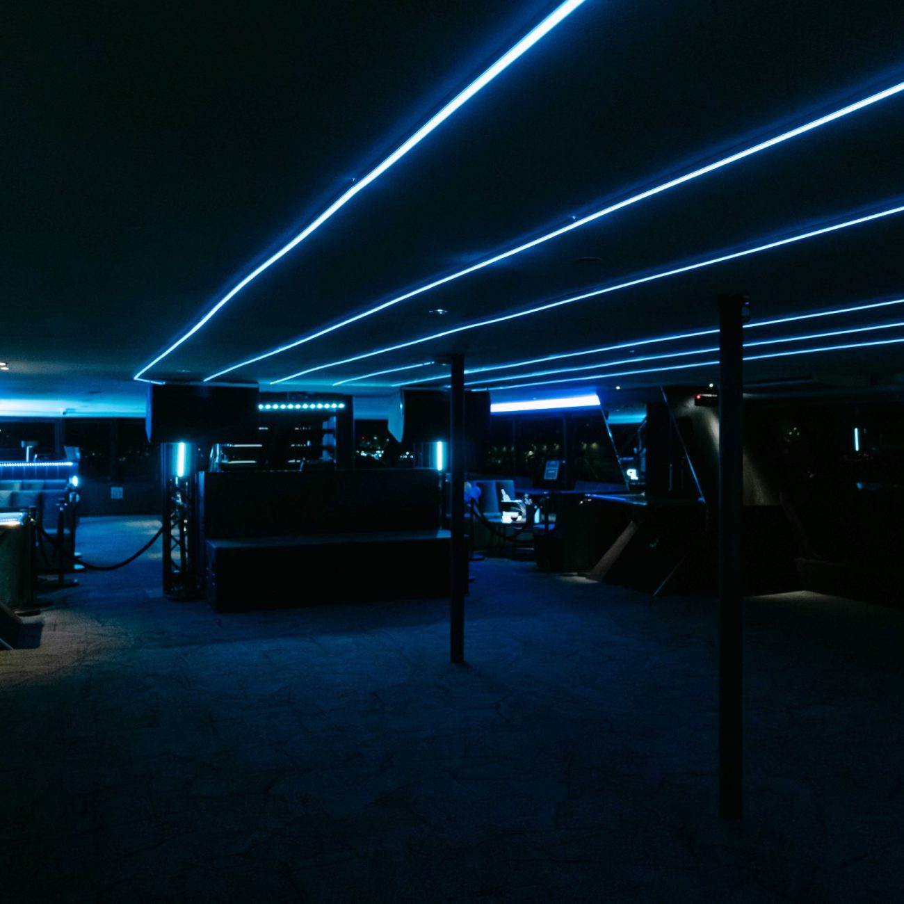 Blue neon-lit interior inside a luxury yacht venue