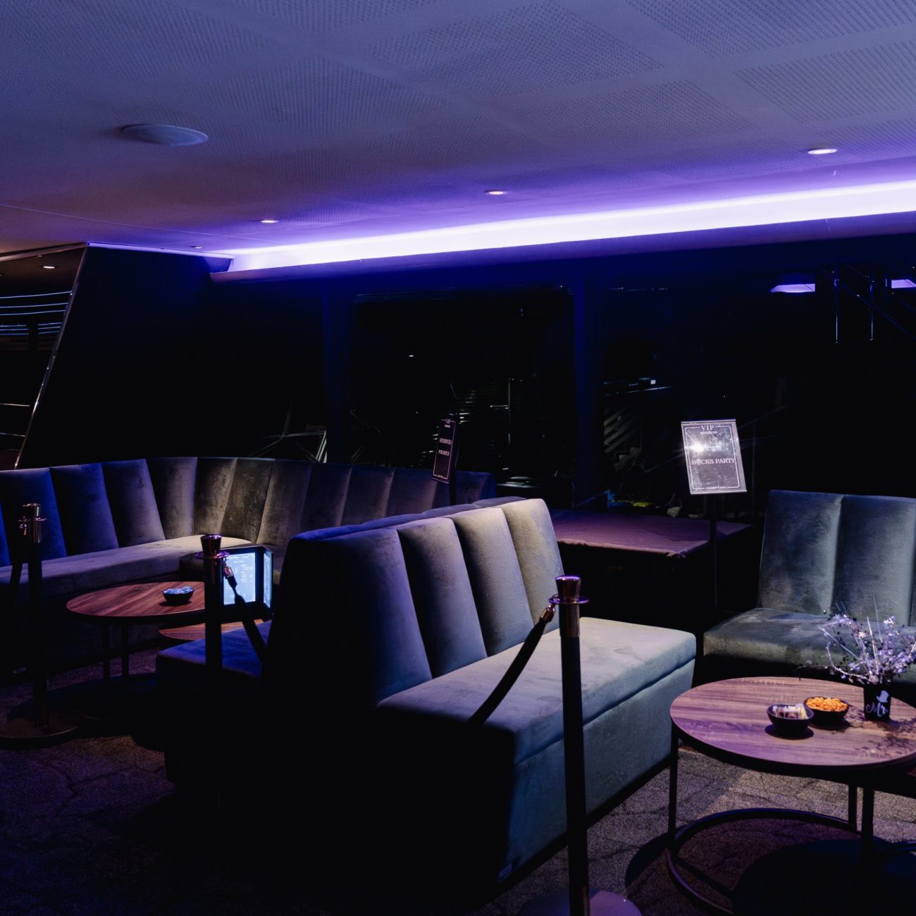 Purple-lit lounge area inside a luxury yacht